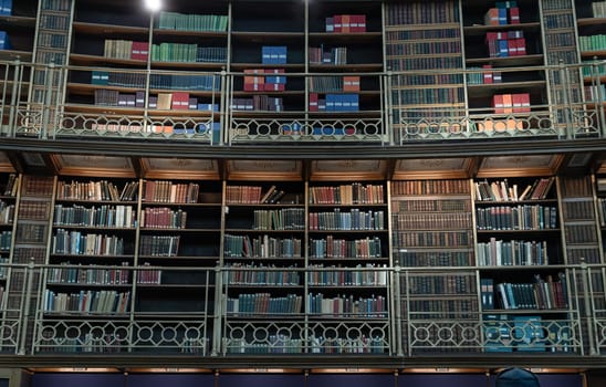 London, UK - May 31, 2025 - Row of many book stack on wooden shelves inside The Reading Room situated in the centre of the Great Court of the British Museum. use it as your Wallpaper, Poster and Space for text, Selective focus.