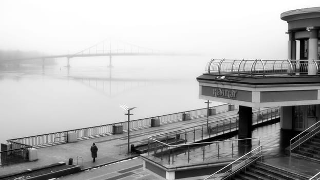 The dense mist obscures the details of the landscape, veiling the quayside in an enigmatic shroud. High quality photo
