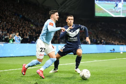 MELBOURNE, AUSTRALIA - MAY 31: Marco Tilio of Melbourne City sprints away from Joshua Rawlins of Melbourne Victory during the A-League Men's Grand Final match between Melbourne City and Melbourne Victory at AAMI Park on May 31, 2025, in Melbourne, Australia.
