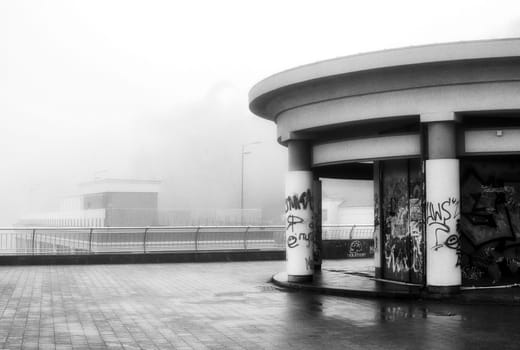 The dense mist obscures the details of the landscape, veiling the quayside in an enigmatic shroud. High quality photo
