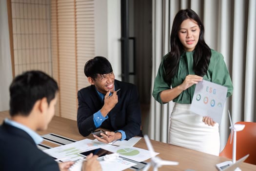 A diverse team collaborates on ESG initiatives, showcasing commitment to sustainability and responsible governance in a professional setting.