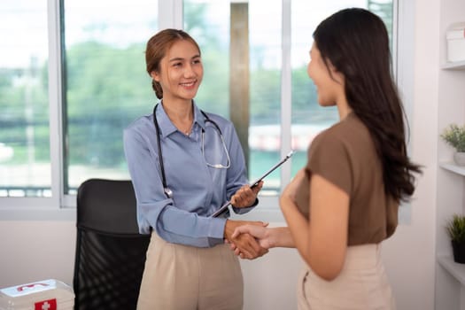A nurse and patient engage in a handshake, highlighting the importance of trust and connection in healthcare.