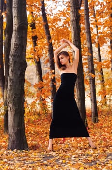 Portrait of a hot young woman in autumn park