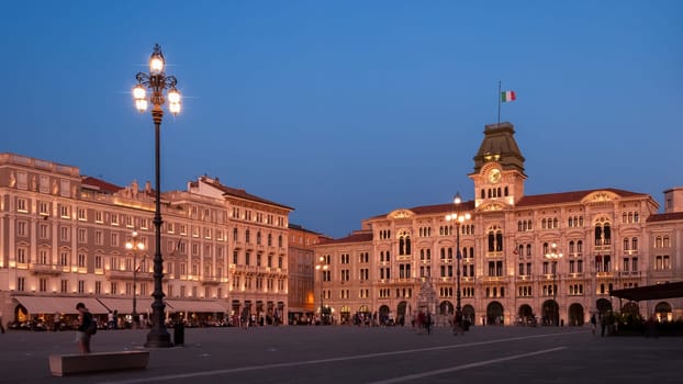 Unity square or Piazza dell'Unita in Trieste, Italy, with and municipality palace or Palazzo del Municipio after sunset. Biggest city square in Europe open to seafront with its city lights on