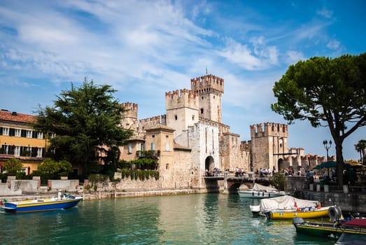 Medieval walls and entrance bridge of Sirmione town, Lake Garda, Lombardy. Sirmione occupies small peninsula on Lake Garda, 13th century town with important castle of Scaliger