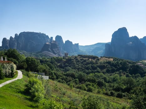 Panoramic view of Meteora rocks on a clear summer day/ Tourist destination, famous natural phenomenon of boulder rocks and religious attraction of Eastern Orthodox monasteries and nunneries atop of rocks.