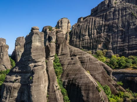 Close view of sedimentary rocky slopes of Meteora rocks, Greece. Natural phenomenon of boulder rocks, unique shapes, famous place, tourist destination of rounded rocks and religious attraction of Eastern Orthodox monasteries and nunneries atop of rocks.