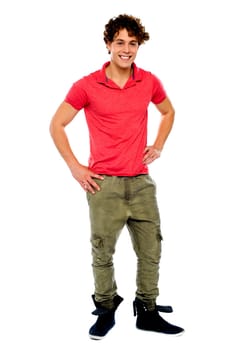 Guy posing with hands on his waist, smiling at camera