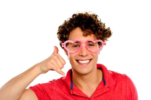 Boy posing with heart shaped eye-wear gesturing call