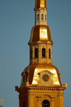 the Peter and Paul Fortress spire at sunset. High quality photo
