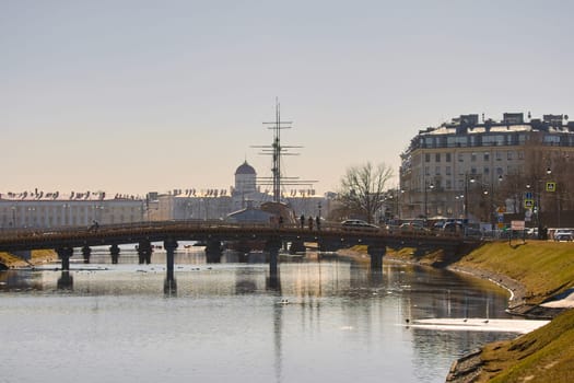 Russia, St.Petersburg, 26 March 2025: Kronverksky Bridge, the first natural line of defense of the Peter and Paul Fortress on a clear spring day, the remains of an ice drift on the river. High quality photo