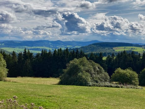 panorama of beautiful countryside of Rhoen, Hesse, Germany. sunny afternoon. wonderful springtime landscape in mountains. grassy field and rolling hills. rural scenery. High quality photo