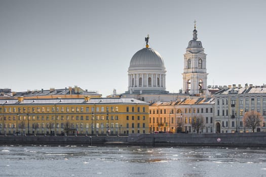 Russia, St.Petersburg, 27 March 2025: Church of St. Catherine the Great Martyr on a sunny spring day, Makarov Embankment, ice drift on the Neva River. High quality photo
