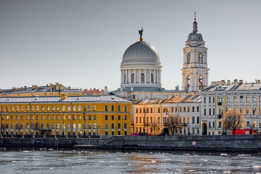 Russia, St.Petersburg, 27 March 2025: Church of St. Catherine the Great Martyr on a sunny spring day, Makarov Embankment, ice drift on the Neva River. High quality photo