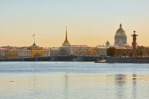 ice drift on the Neva River with a view of the arrow of Vasilyevsky Island with rostral columns, the Winter Palace, St. Isaac's Cathedral, the Savior on Spilled Blood. High quality photo