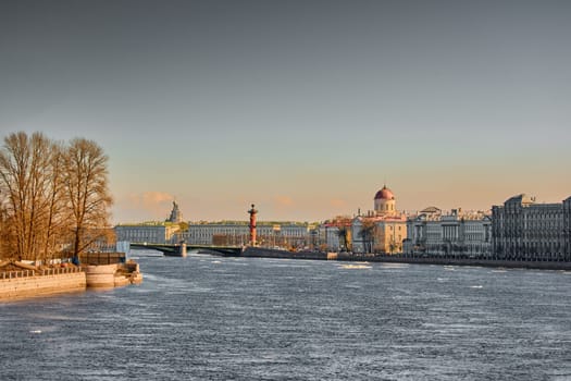 ice drift on the Neva River with a view of the arrow of Vasilyevsky Island with rostral columns, the Winter Palace, St. Isaac's Cathedral, the Savior on Spilled Blood. High quality photo