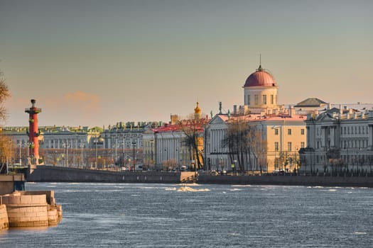 ice drift on the Neva River with a view of the arrow of Vasilyevsky Island with rostral columns, the Winter Palace, St. Isaac's Cathedral, the Savior on Spilled Blood. High quality photo