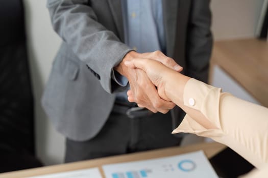 A close-up of a handshake between business partners, symbolizing agreement and collaboration in a professional environment.