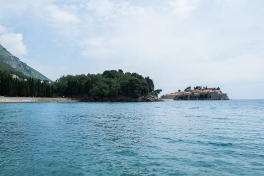 Sveti Stefan private island in Montenegro near Budva. Adriatic Sea Coast travel destination vacation holiday idea. Concept of getting away tourism experiences. Nature driven scenery wanderlust vibes
