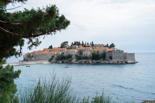 Sveti Stefan private island in Montenegro near Budva. Adriatic Sea Coast travel destination vacation holiday idea. Concept of getting away tourism experiences. Nature driven scenery wanderlust vibes