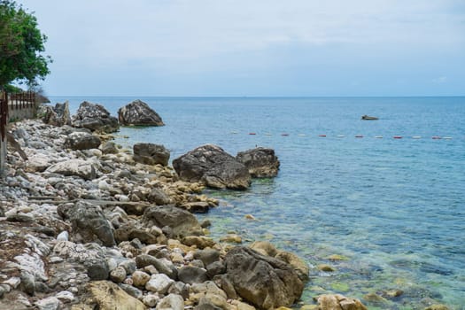 Beautiful rocks and bright turquoise water among layered rocks near Budva, Montenegro. Tropical summer landscape exotic beach on the Adriatic Sea. Vacation holiday idea