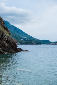 Beautiful rocks and bright turquoise water among layered rocks near Budva, Montenegro. Tropical summer landscape exotic beach on the Adriatic Sea. Vacation holiday idea