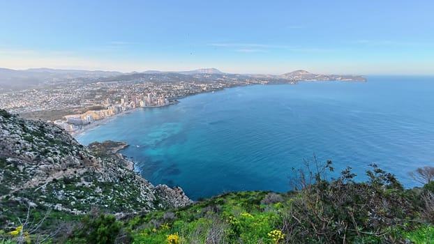 A breathtaking coastal panorama that beautifully showcases towering cliffs, the vast ocean, and vibrant greenery