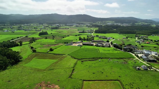 An absolutely stunning aerial view showcasing the vast, lush green fields along with serene rural landscapes