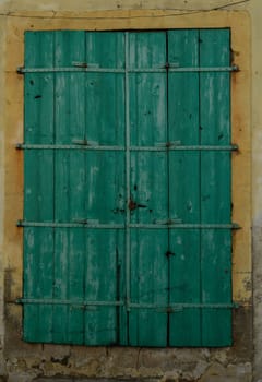 Traditional green wooden door serves as the entrance to a charming Cypriot home, highlighting local architecture and Mediterranean character.