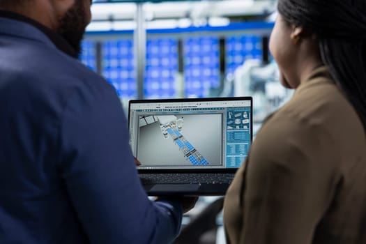 African american team of energy consultants analyzing insight in solar panel plant, ensuring high standards in renewable energy production line, quality control and manufacturing efficiency.