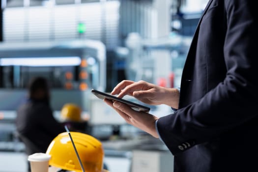 Operations director in a solar panel factory monitoring efficiency metrics and system outputs, combining leadership with real time quality inspection and strategic business development.