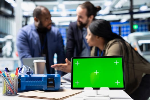 Multiethnic group of technicians work with copy space in a solar energy plant, shares ideas on improving systems and emphasizing strategic planning for technical development.