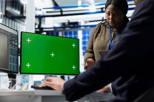 Solar tech workforce reviews diagnostics on pc next to mockup, supporting clean smart energy production and manufacturing process evolution. Working on sustainable solutions at the plant.