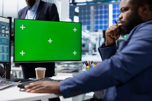 African american energy expert looks at copy space display in solar power plant, working on photovoltaics design and factory implementation. Corporate oversight with expertise.