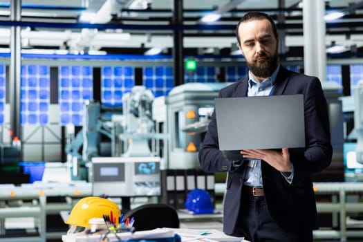 Executive consultant oversees solar energy systems in industrial workplace, emphasizing strategic planning for sustainable energy development. Innovation in clean power production line.