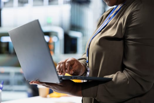 Woman professional checking system diagnostics in a solar panel plant used for manufacturing, illustrating corporate leadership for sustainable energy in efficient industrial operations.