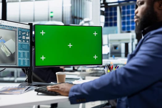 Solar plant employee records inspection notes next to chroma key, actively supporting renewable power goals through precision and workplace accountability. Managing the production.