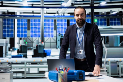 Industrial consultant examines high tech solar energy production line, reviewing insights for clean power improvements, renewable systems design and smart infrastructure planning.