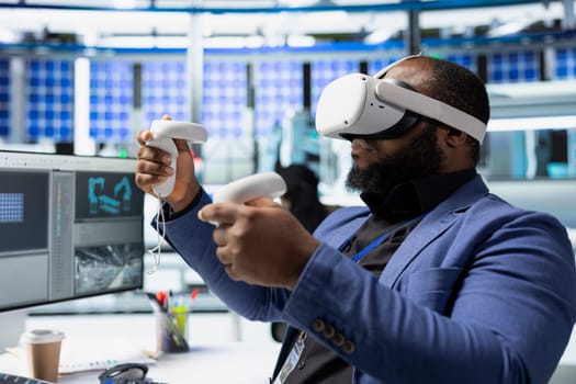 African american master engineer using VR headset to improve solar energy automation, eco friendly. Photovoltaics manufacturing plant specialist using virtual reality equipment, high tech.