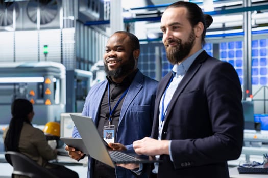 Factory inspectors and supervisors engaging in briefing over production metrics, supporting industrial innovation and sustainable process improvement. Solar power manufacturing.