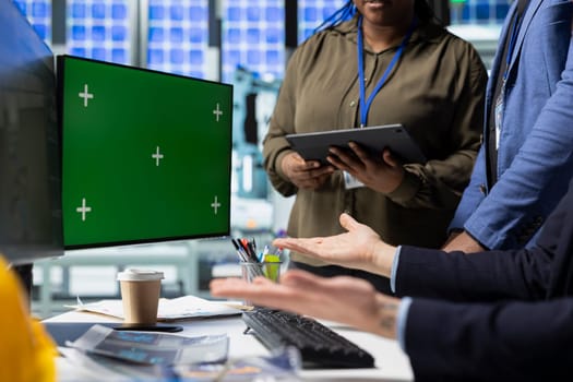 Coworkers brainstorming solutions with mockup display in solar plant, advancing industrial goals through collaboration and corporate responsibility. Team of engineers share insight.