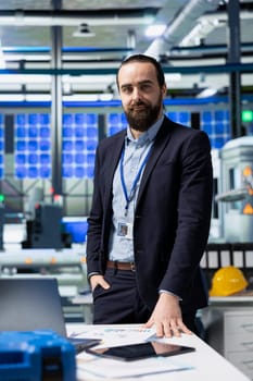 Manufacturing analyst reviewing solar panel production workflow, focusing on technological precision and sustainable power development in a high tech industrial environment.