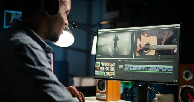 Young man video creator working on editing a movie montage project, multitasking with dual monitors. Male footage editor starting the cinematic creative process, film editing industry. Camera A.
