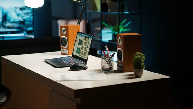 Stylish apartment with a spacious home office and wooden furniture, a cozy TV lounge, decorative house plants and a minimalist design create a modern comfortable workspace and living area.
