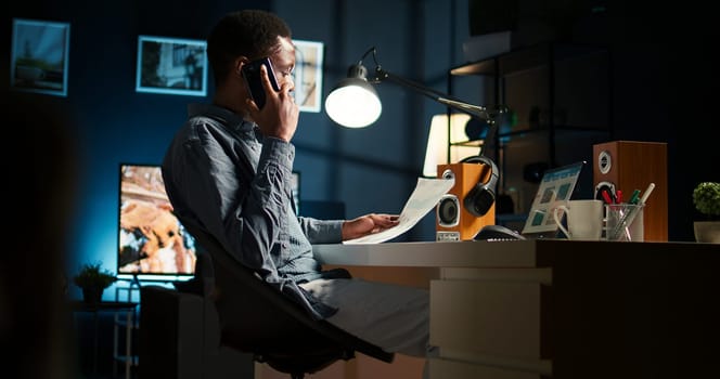 Male freelancer calling financial expert at home to discuss about monthly funds balance, increase profit with global investments. Young guy talking to advisor about capital resources. Camera A.