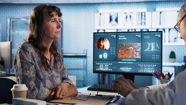 Doctor provides cancer screening guidance to a patient in office, discussing MRI scans and tumor growth. Early detection and preventative medicine are emphasized for better health outcomes. Camera A.