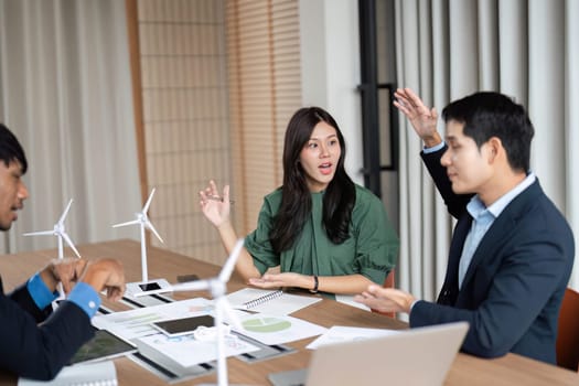 A team actively engages in conversation about ESG initiatives and sustainable practices during a meeting.
