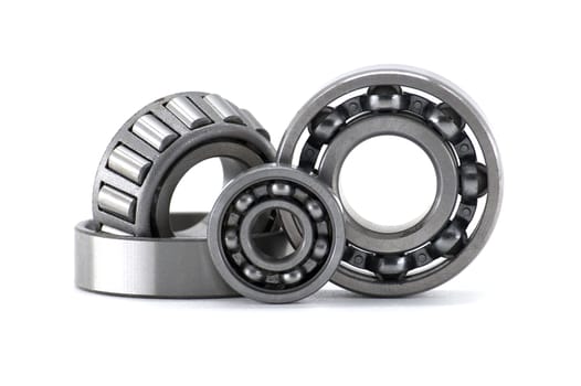 A close-up shot featuring a detailed view of various ball bearings and roller bearings against a clean white background.