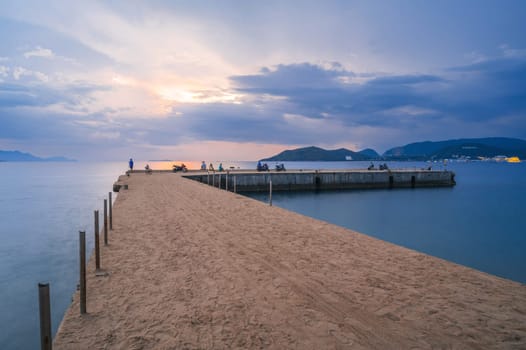 Pier in the sea at sunrise in morning. View of Vinpearl Island in Nha Trang in Vietnam