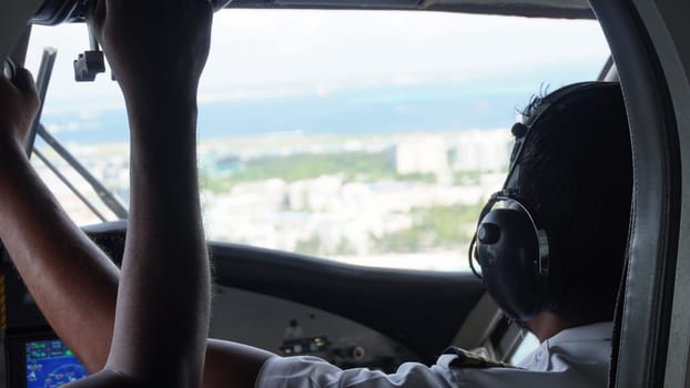 The pilot skillfully guides the aircraft towards the runway, offering a captivating view from the cockpit as they prepare for a smooth landing in a tropical paradise